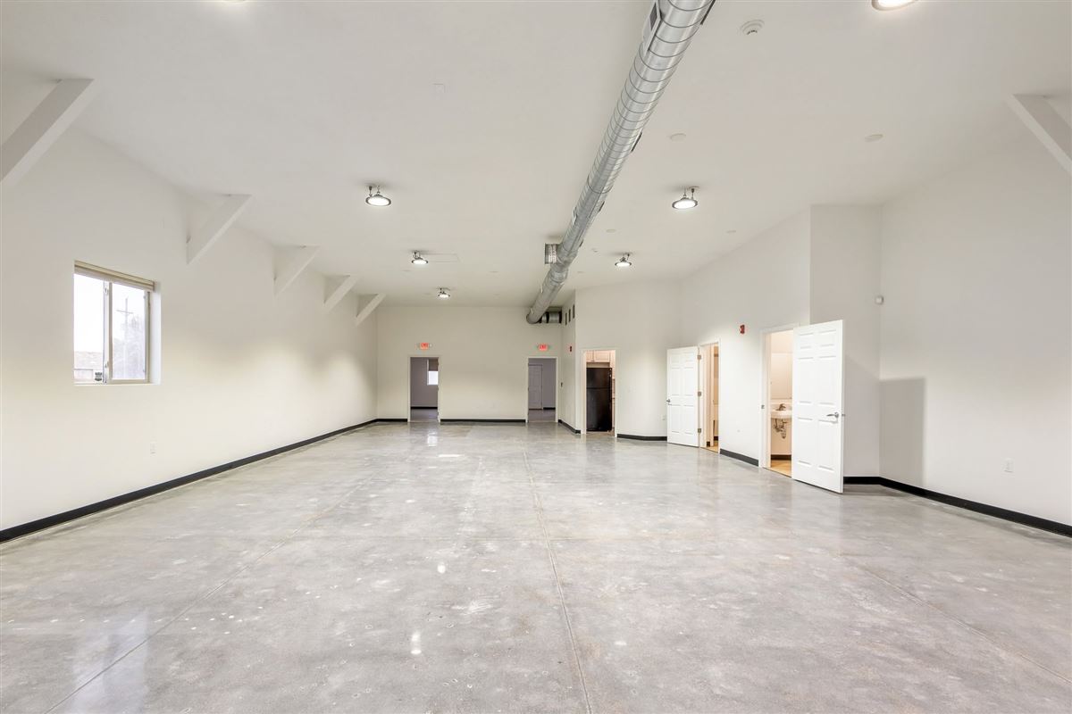 Long view of the Valley Venue event hall showing kitchen and restroom access
